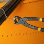 Close-up of Tolsen 8 inch tower pincer gripping thin metal wire