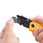 Hands demonstrating blade replacement on a Tolsen utility knife
