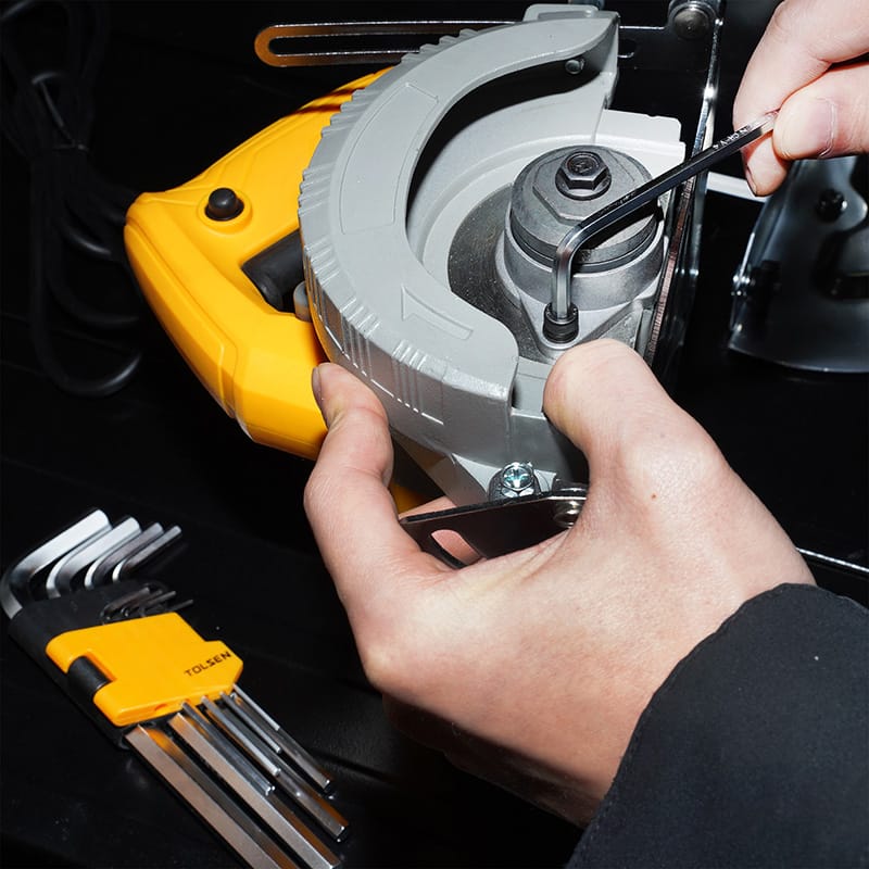 Hands using a hex key from the Tolsen 9pcs long arm hex key set to adjust a power tool