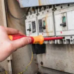 Using insulated screwdriver from Tolsen 15Pcs Insulated Hand Tools Set on electrical panel