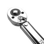 Close-up of the reversible ratchet head mechanism and quick-release button on Tolsen torque wrench.