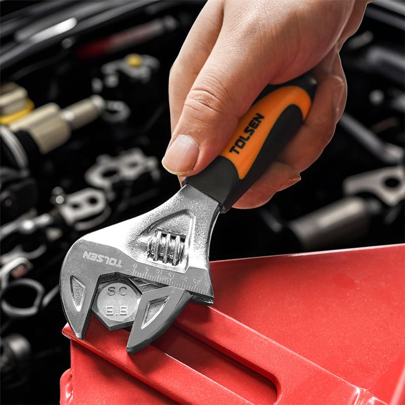 Close-up of a hand using a Tolsen 6.5-inch stubby adjustable wrench to turn a bolt