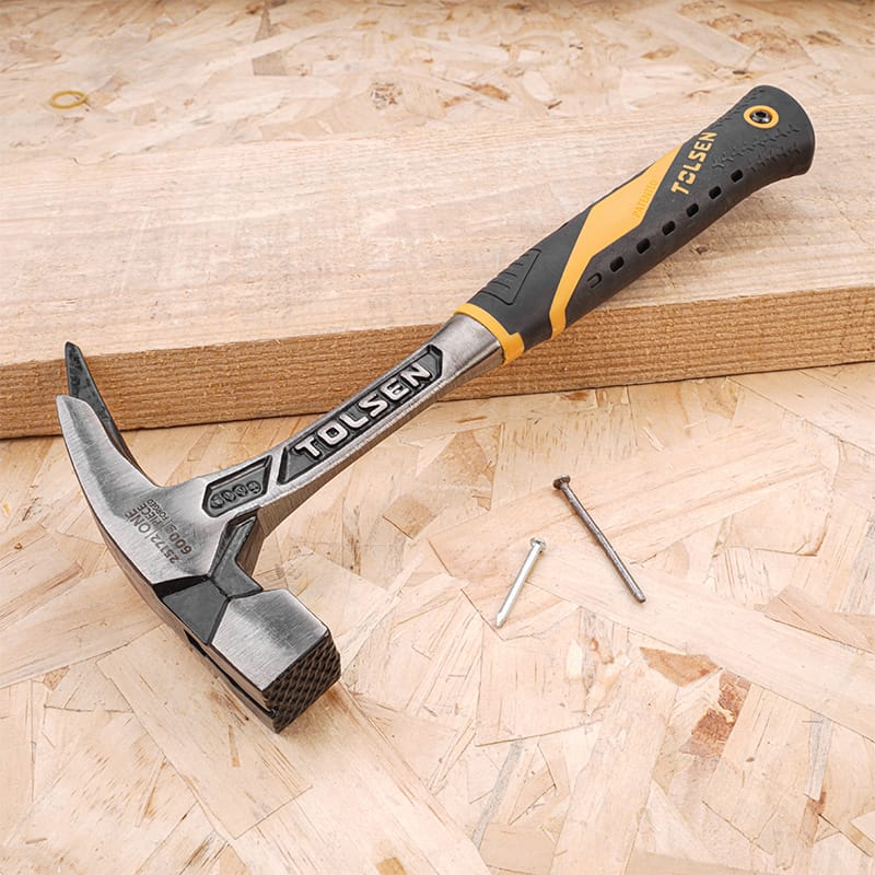 Tolsen one-piece forged roofing hammer and two nails on a wooden board