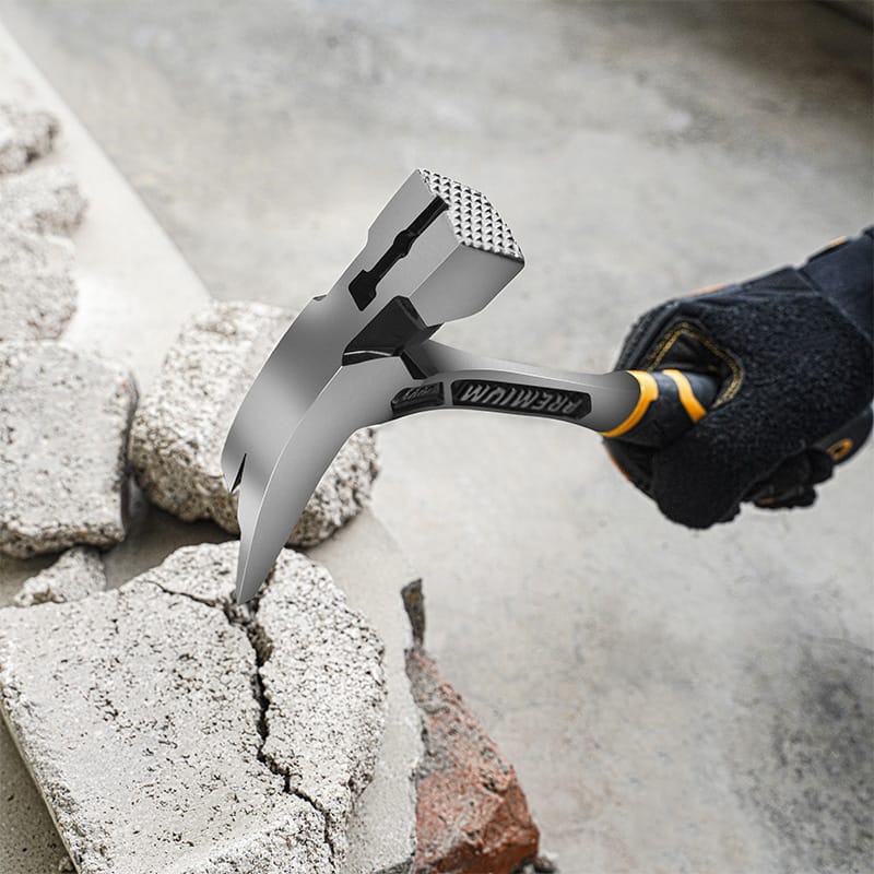 Tolsen one-piece forged roofing hammer being used to break apart concrete or masonry