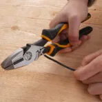 Close-up of Tolsen high leverage lineman's pliers crimping wire