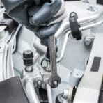 Close-up of gloved hand using a Tolsen 13mm combination spanner from the 5pcs set on automotive equipment