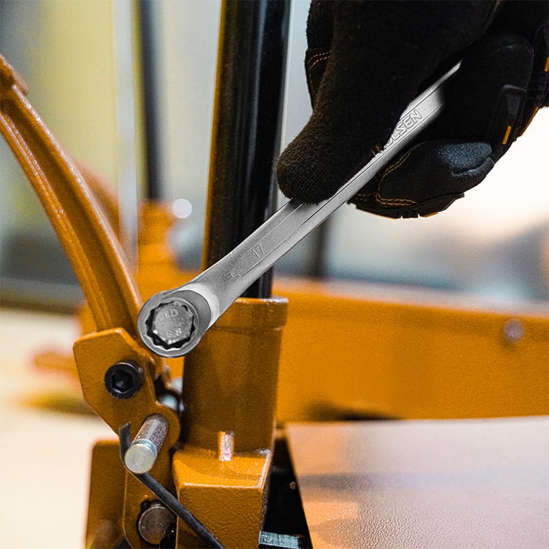 Demonstration of using a TOLSEN 75-degree offset spanner to reach and tighten a bolt on a vertical machine part