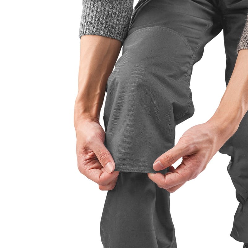 Close-up of the durable grey fabric and hem stitching on the leg of Tolsen work pants.