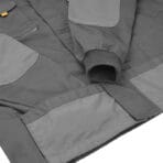 Detailed view of Tolsen industrial jacket grey fabric, stitching, and pocket construction.