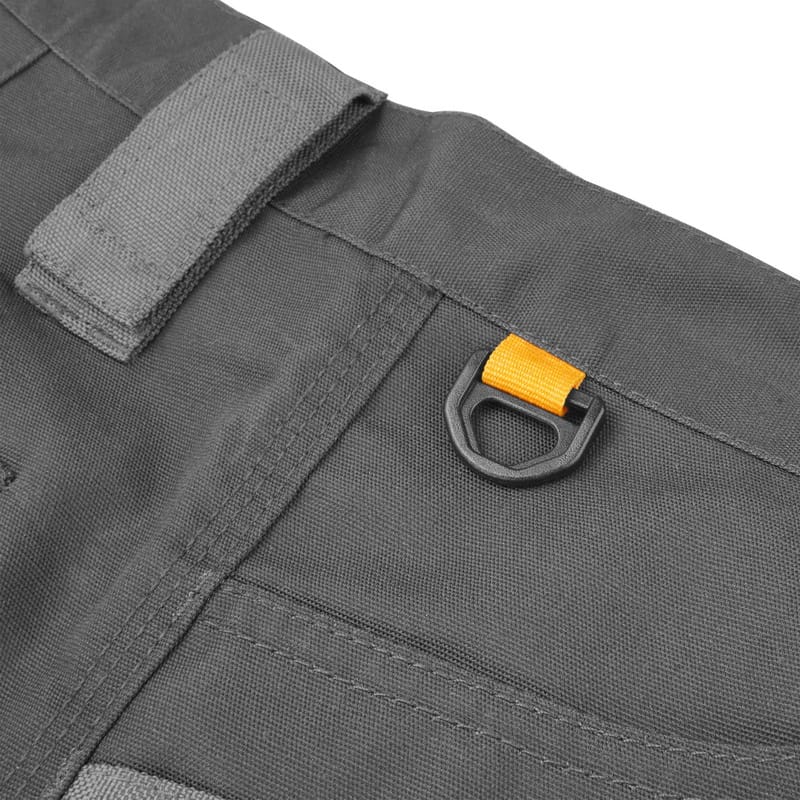Durable plastic D-ring and velcro tool loop attachment point on the waistband of Tolsen work trousers.