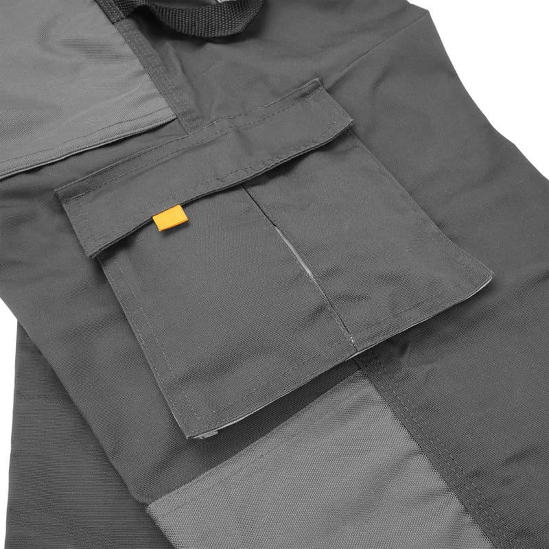 Detail of the side cargo pocket on Tolsen work pants with a secure velcro flap and orange tag accent.
