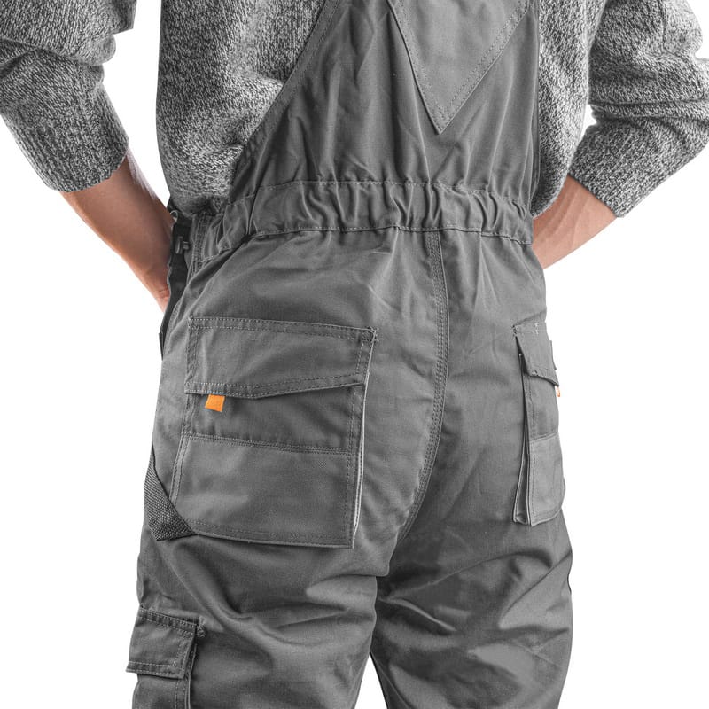 Rear view of Tolsen overalls on a model, showing spacious back pockets and the elasticated waistband for comfort.
