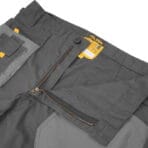 Close-up of Tolsen working trousers waistband featuring a durable metal zipper, button closure, and CE certification label.