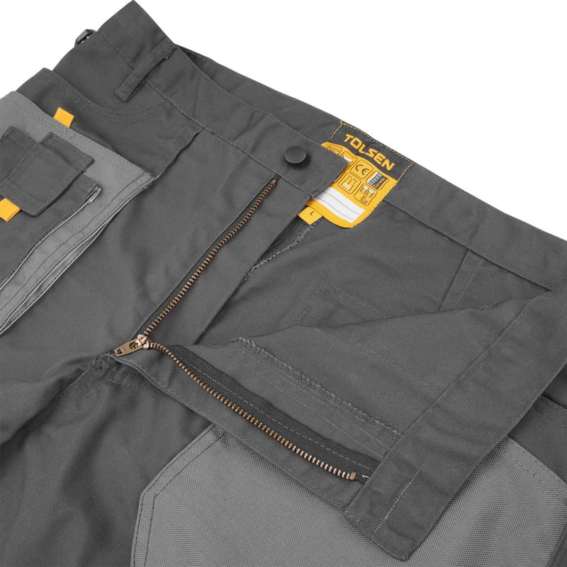 Close-up of Tolsen working trousers waistband featuring a durable metal zipper, button closure, and CE certification label.