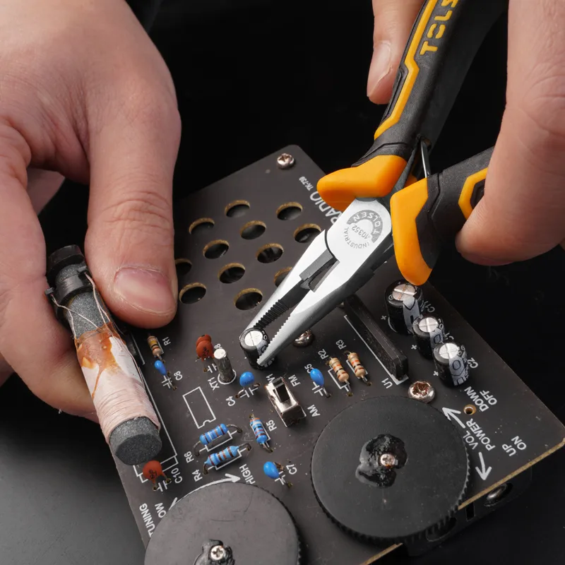 Close-up of hand using Tolsen 4.5 inch mini long nose pliers to work on a circuit board