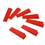 Group of red plastic tile leveling wedges showing the ribbed surface designed for secure tile installation.