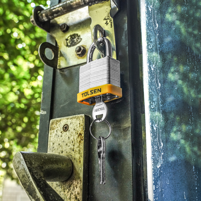 Tolsen Laminated Padlock securing an outdoor gate hasp with keys attached
