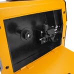 Internal compartment of Tolsen MIG DC welder featuring the wire spool holder and adjustable wire feed drive mechanism.