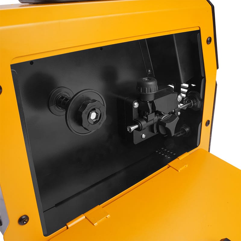 Internal compartment of Tolsen MIG DC welder featuring the wire spool holder and adjustable wire feed drive mechanism.
