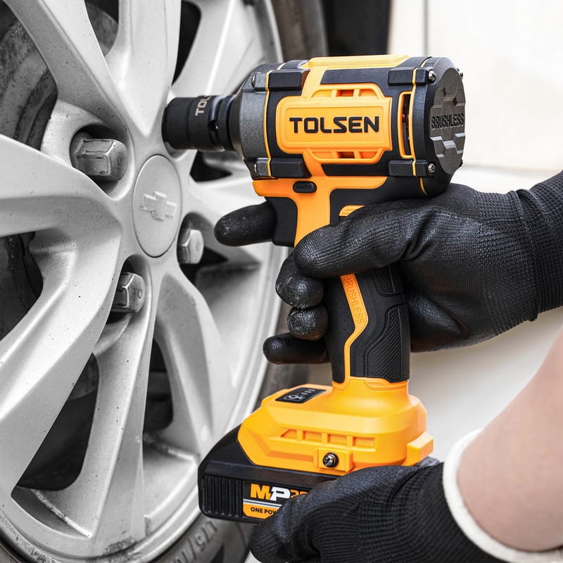 A person using Tolsen 20V brushless cordless impact wrench to tighten the car wheel lug nuts