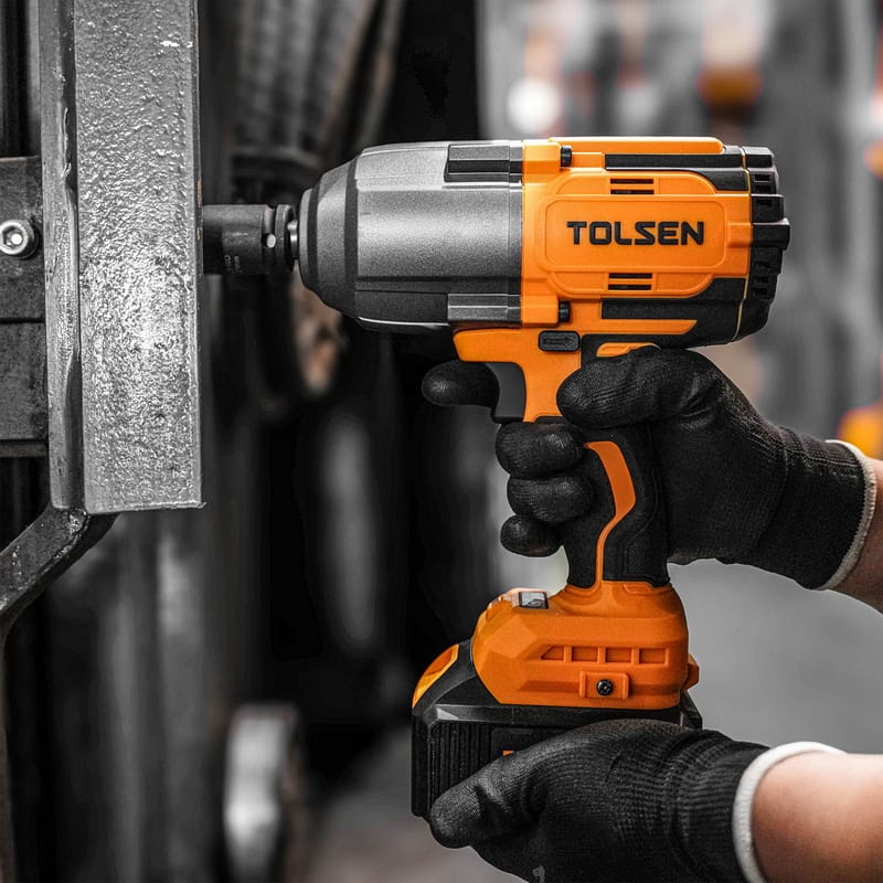 Tolsen 20V brushless cordless impact wrench tightening a bolt on a metal beam