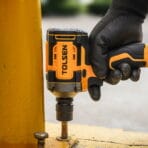 Tolsen 20V brushless cordless impact wrench tightening a bolt on a metal surface