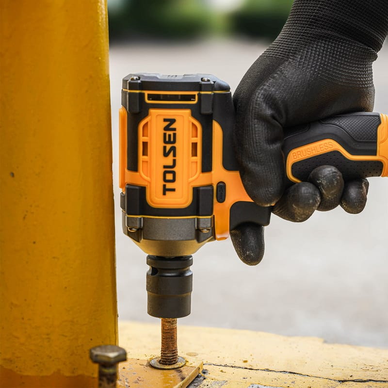 Tolsen 20V brushless cordless impact wrench tightening a bolt on a metal surface