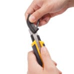 User removing the built-in blade snapper tool from the tail cap of the Tolsen utility knife.