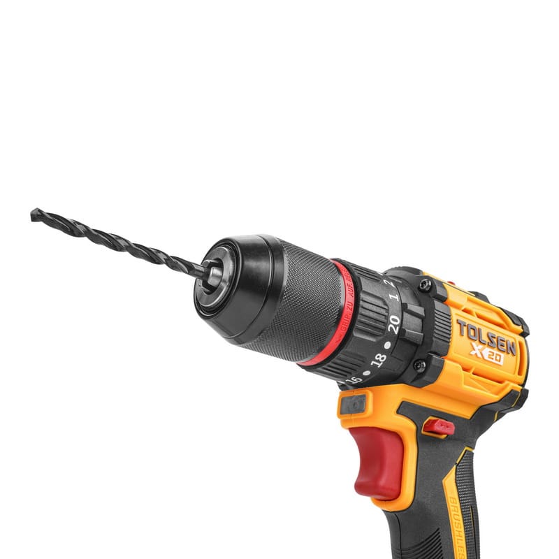 Angled view of the TOLSEN X20 brushless drill with a black twist drill bit securely fastened in the keyless metal chuck, ready for use.