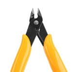 Detailed view of the open cutting jaws on the TOLSEN diagonal flush cutter, revealing the sharp blades and the internal return spring mechanism.
